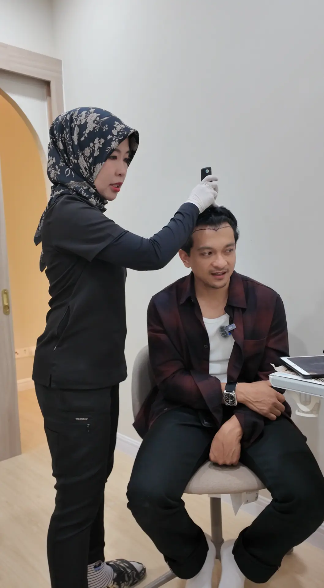 Dr Deena designing and marking a patient's new hairline before FUE surgery at Thrive Hair Clinic