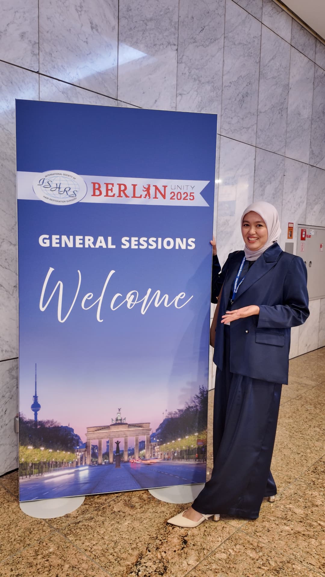 Dr Aisa at the ISHRS Berlin Unity 2025 welcome sign