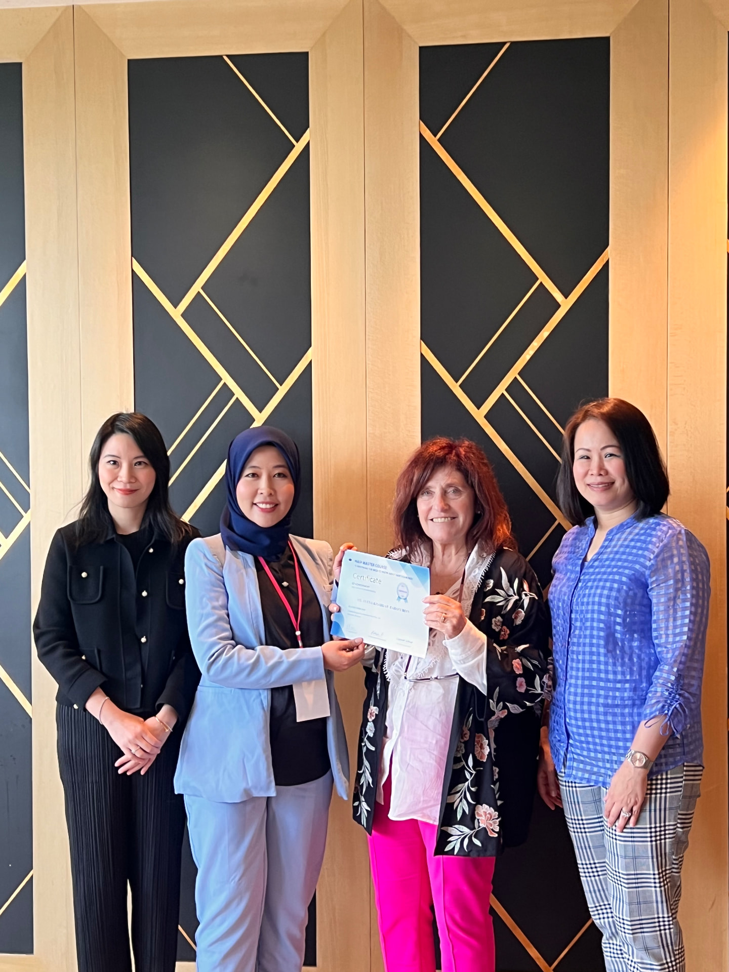 Dr Deena receiving a certificate at an international hair restoration master course