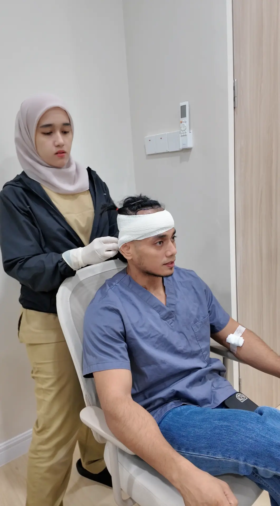 Patient with a protective head bandage immediately after FUE at Thrive Hair Clinic